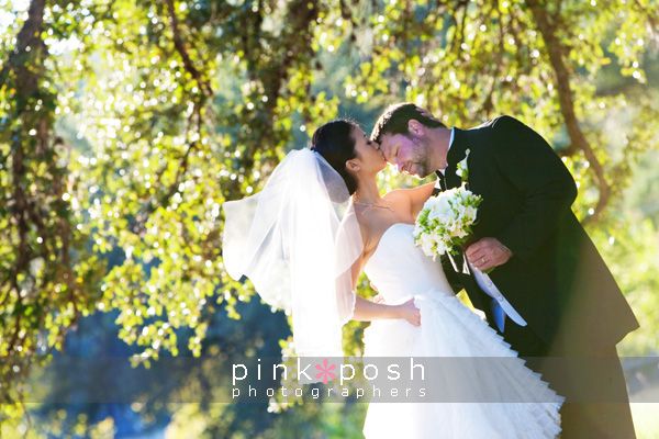 Bride kissing groom on the forehead